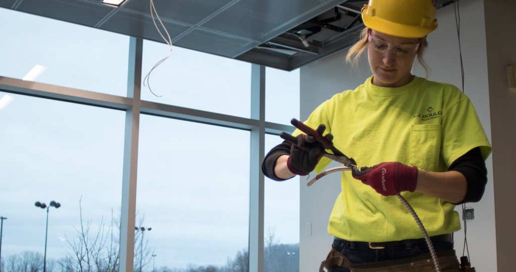 Electrician cutting wiring sheathing