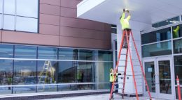 View of two electricians working on Lakeland exterior wiring