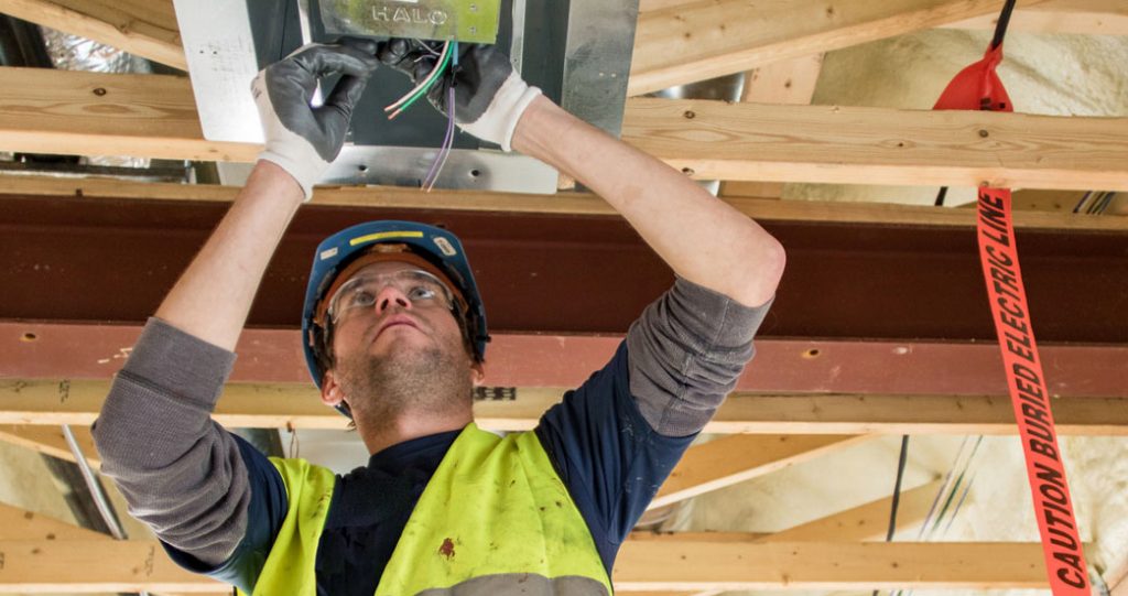 Electrician working on wiring ceiling control box